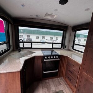 RV kitchen interior with stove and sink.